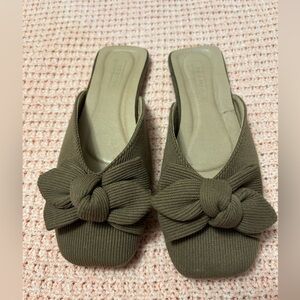 Khaki knit mules with bow detail .
